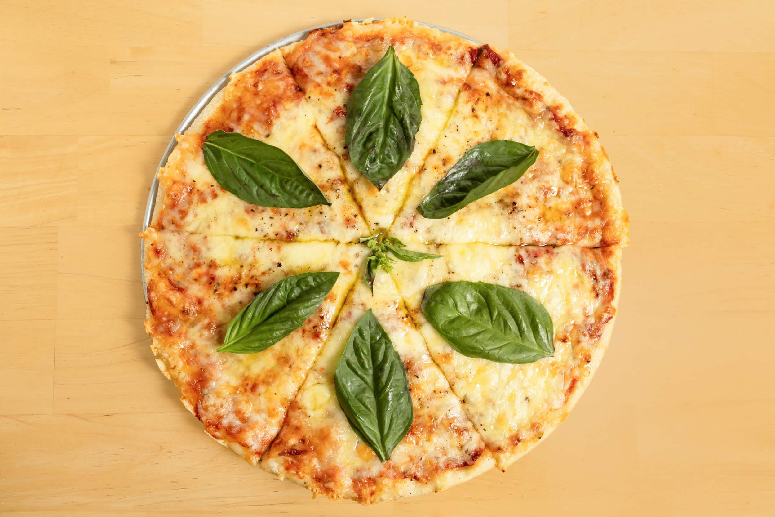 Bee's Cheese pizza with fresh basil, straight from the oven